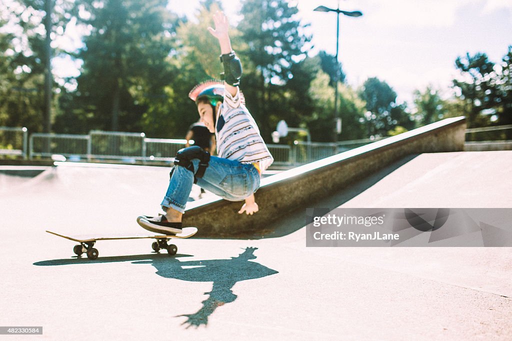 Boy Falling off Skateboard at Skate Park