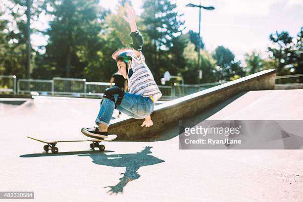 boy falling off skateboard at skate park - skating stock pictures, royalty-free photos & images