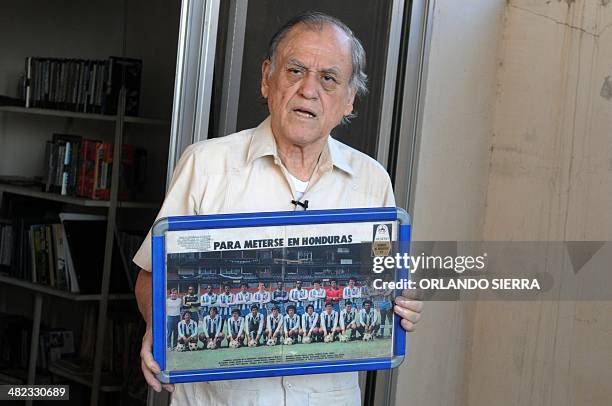 The coach of the Olimpia football club lower divisions Jose de la Paz Herrera Ucles, know as "Chelato Ucles", shows a picture of the Hondurean team...