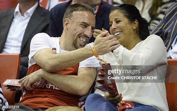 Bayern Munich's French football midfielder Franck Ribery and his wife Wahiba Belhami joke together during the Euroleague top 16ten match FC Bayern...