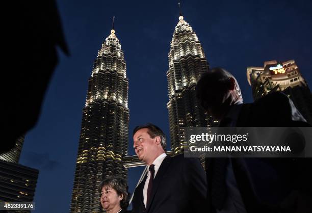 Britain's Prime Minister David Cameron arrives to address a gathering during a business event in the backdrop of Malaysia's iconic twin towers at the...