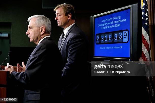 Senators Jack Reed , left, and Dean Heller , standing in front of a screen showing an increasing number count to represent the number of Americans...