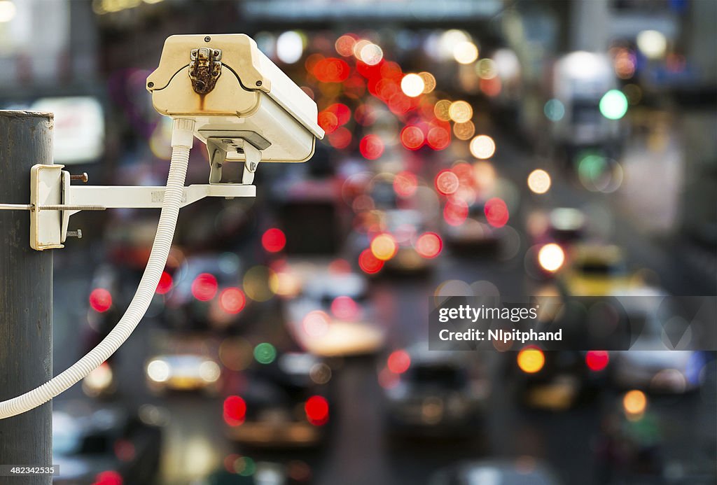 Back view of CCTV Camera with traffic jam light bokeh