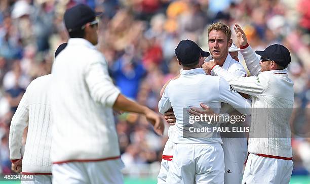 England's Stuart Broad celebrates taking the wicket of Australia's Chris Rogers for 6 runs on the second day of the third Ashes cricket test match...