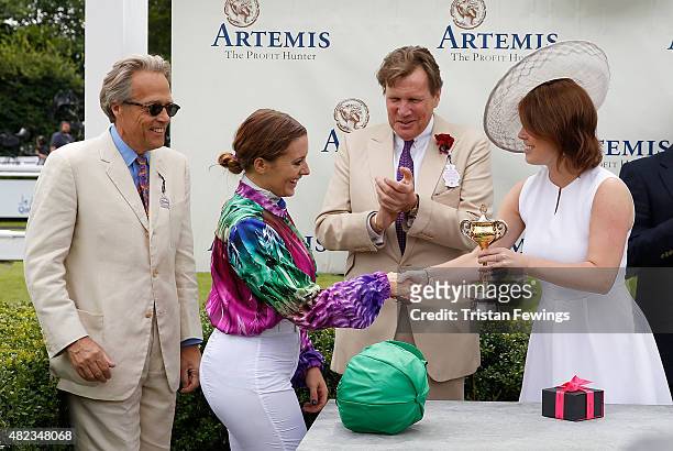 Princess Eugenie presents the winning jockey Camilla Henderson with the cup, as Lord March and jeweller Theo Fennell look on, on day three of the...