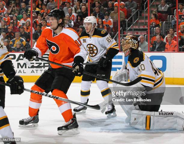 Tye McGinn of the Philadelphia Flyers battles in the crease against Kevan Miller and Tuukka Rask of the Boston Bruins on March 30, 2014 at the Wells...