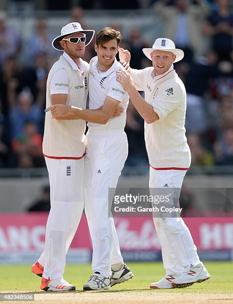 Steven Finn of England celebrates with teammates Stuart Broad and Ben Stokes after dismissing Steven Smith of Australia during day two of the 3rd...