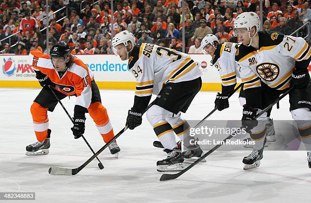 Tye McGinn of the Philadelphia Flyers line up on a face-off against Carl Soderberg, Dougie Hamiliton and Loui Eriksson of the Boston Bruins on March...