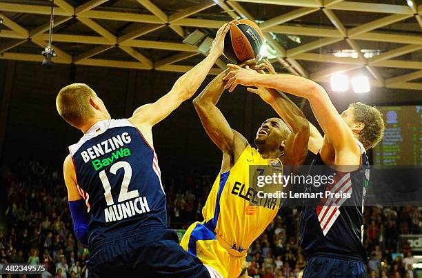 Robin Benzing and John Bryant of Munich challenge Ricky Hickman of Tel Aviv during the Turkish Airlines Euroleague Top 16 Round 13 Group F basketball...