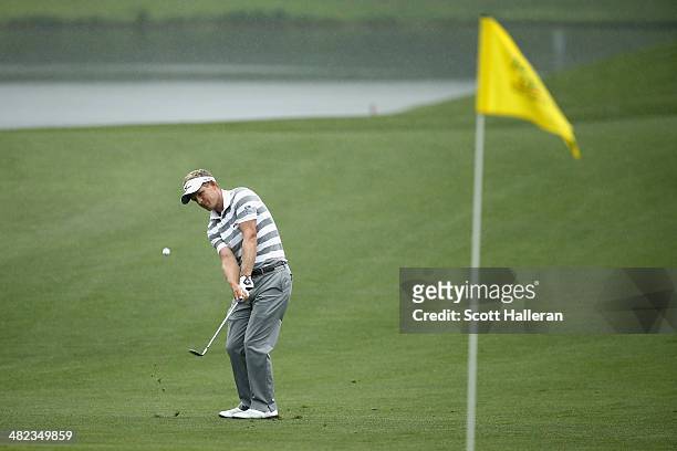 Luke Donald of England hits a chip shot on the the eighth green during round one of the Shell Houston Open at the Golf Club of Houston on April 3,...