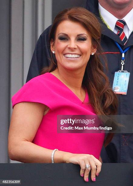 Coleen Rooney watches the racing as she attends day 1 of the Crabbie's Grand National horse racing meet at Aintree Racecourse on April 3, 2014 in...