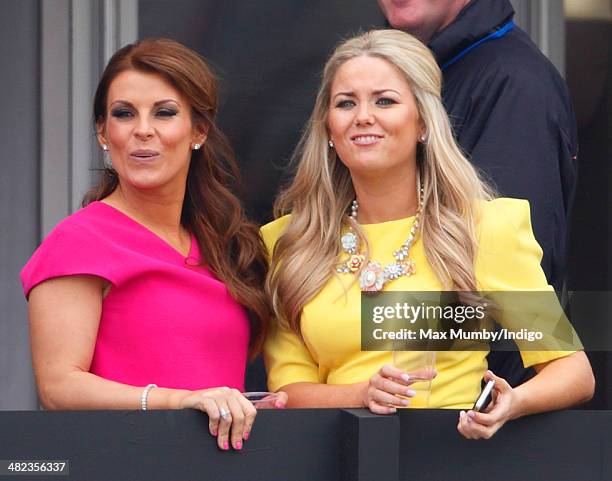 Coleen Rooney watches the racing as she attends day 1 of the Crabbie's Grand National horse racing meet at Aintree Racecourse on April 3, 2014 in...