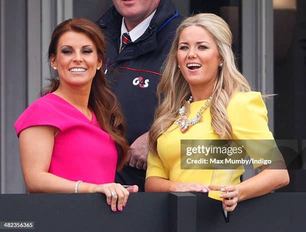 Coleen Rooney watches the racing as she attends day 1 of the Crabbie's Grand National horse racing meet at Aintree Racecourse on April 3, 2014 in...