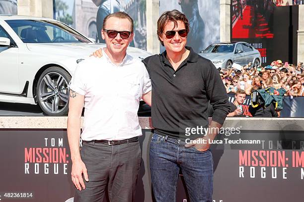 Simon Peg and Tom Cruise attend the world premiere for the film 'Mission Impossible - Rogue Nation' at Staatsoper on July 23, 2015 in Vienna, Austria.