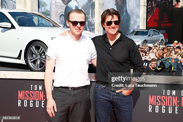 Simon Peg and Tom Cruise attend the world premiere for the film 'Mission Impossible - Rogue Nation' at Staatsoper on July 23, 2015 in Vienna, Austria.