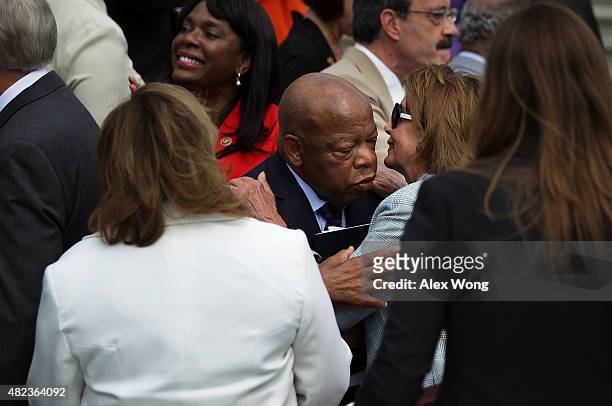 House Democratic Leader Rep. Nancy Pelosi greets Rep. John Lewis during a rally in front of the U.S. Capitol July 30, 2015 in Washington, DC. House...