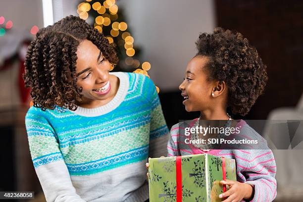 african american mom opening christmas present with preschool age daughter - giving a girl head stock pictures, royalty-free photos & images