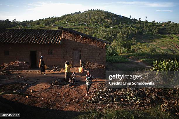 Julian Mokagihana and her family prepare for their evening meal at their rural home about 70 kilometers south of the capital Kigali April 3, 2014 in...