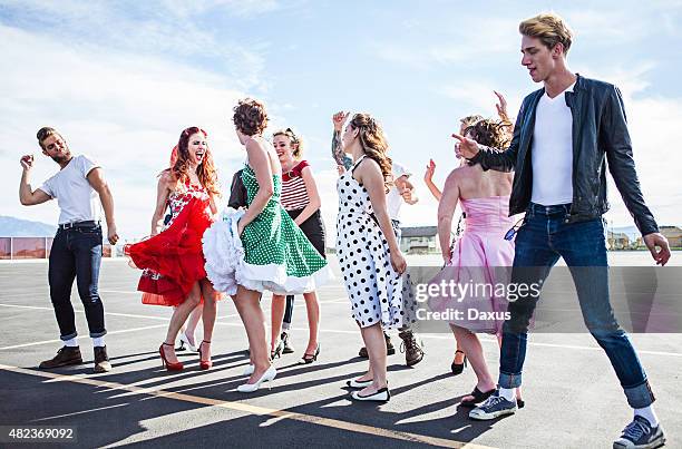 group of friends dancing outside - 1950 2015 stock pictures, royalty-free photos & images