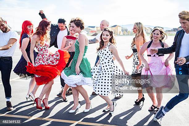 group of friends dancing outside - 1950 2015 stock pictures, royalty-free photos & images