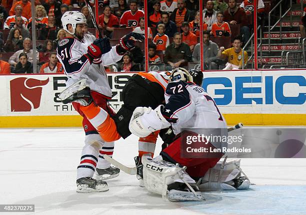 Tye McGinn of the Philadelphia Flyers is checked into goaltender Sergei Bobrovsky of the Columbus Blue Jackets by Fedor Tyutin on April 3, 2014 at...