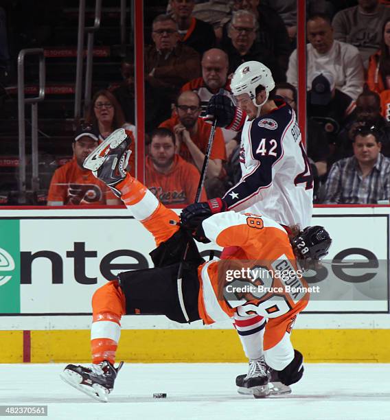 Artem Anisimov of the Columbus Blue Jackets flips Claude Giroux of the Philadelphia Flyers off the first period faceoff at the Wells Fargo Center on...