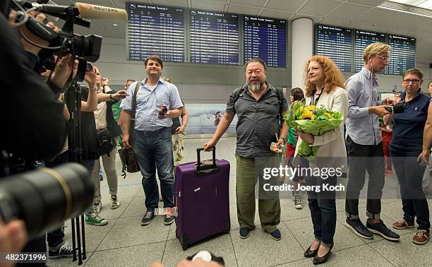 Chinese dissident artist Ai Weiwei is greeted by Parliamentary leader of the Bavarian Green Party Margarete Bause upon his arrival at Munich Airport...