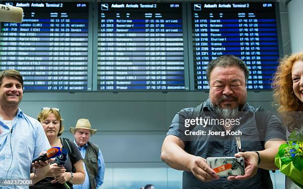 Chinese dissident artist Ai Weiwei is greeted by Parliamentary leader of the Bavarian Green Party Margarete Bause upon his arrival at Munich Airport...