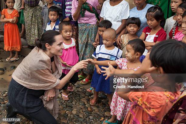 In this handout photo provided by the Maddox Jolie-Pitt Foundation, actress and activist Angelina Jolie Pitt meets children during a visit to Ja Mai...