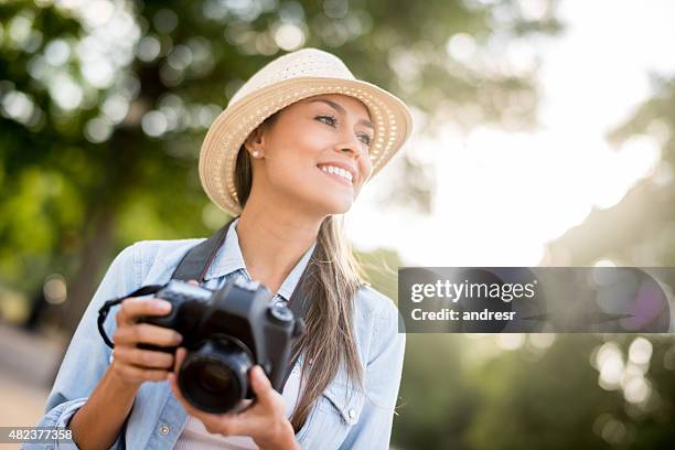 female photographer taking pictures outdoors - safari park stockfoto's en -beelden