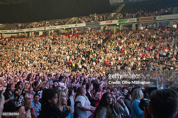 The crowd watch on as Mark Ronson performs during Key 106 Summer Live at Manchester Arena on July 19, 2015 in Manchester, England.