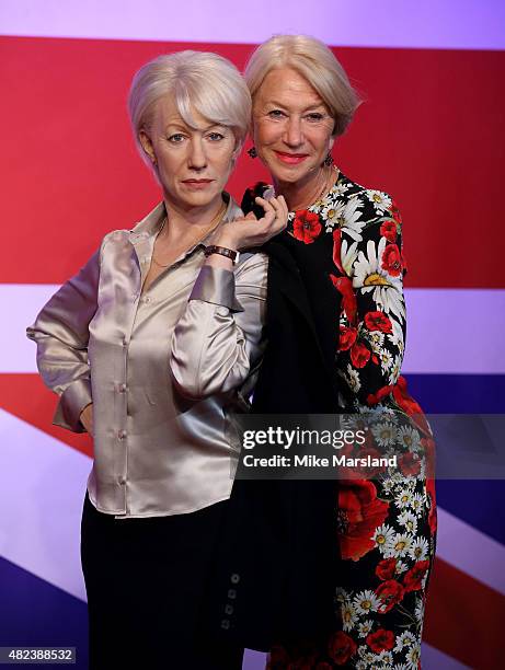 Actress Helen Mirren meets her 3 wax figures at Madame Tussauds on July 30, 2015 in London, England.