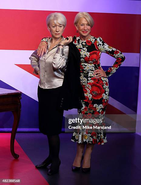 Actress Helen Mirren meets her 3 wax figures at Madame Tussauds on July 30, 2015 in London, England.