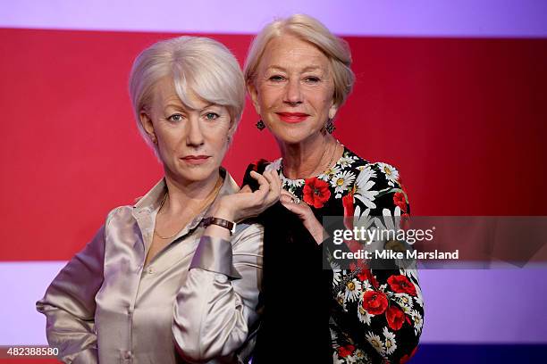 Actress Helen Mirren meets her 3 wax figures at Madame Tussauds on July 30, 2015 in London, England.