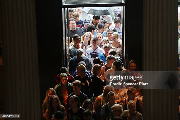 People enter the Metropolitan Museum of Art on July 30, 2015 in New York City. The Met recently announced that it drew 6.3 million visitors in the...
