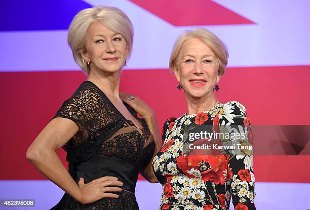 Dame Helen Mirren comes face to face with three waxwork figures of herself today at Madame Tussauds on July 30, 2015 in London, England.