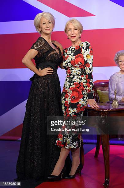 Dame Helen Mirren comes face to face with three waxwork figures of herself today at Madame Tussauds on July 30, 2015 in London, England.