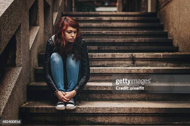 depressed teenager sitting lonely outdoors - family problems stock pictures, royalty-free photos & images