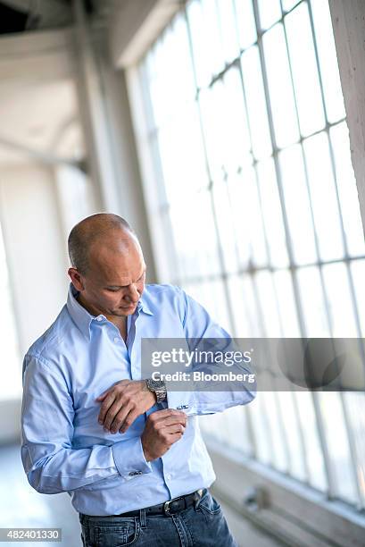 Tony Fadell, founder and chief executive officer of Nest Labs Inc., adjusts his cuff while standing for a photograph after a Bloomberg Studio 1.0...