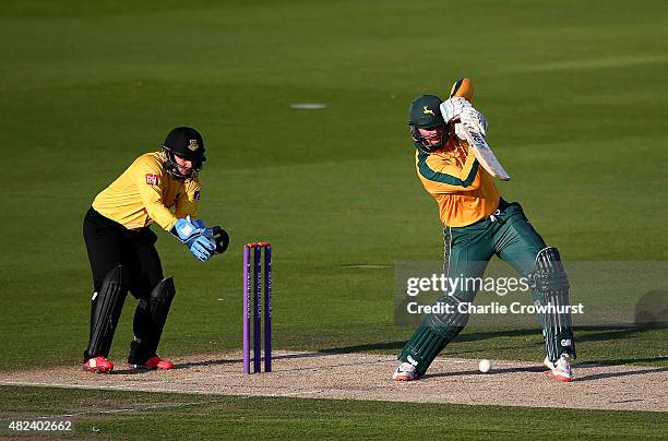 Brendan Taylor of Nottinghamshire hits out while Craig Cachopa of Sussex looks on during the Royal London One-Day Cup match between Sussex and...