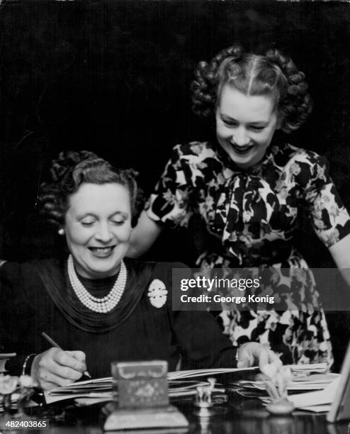 Novelist Barbara Cartland with her daughter Raine McCorquodale, arranging her daughters upcoming wedding, 1948.