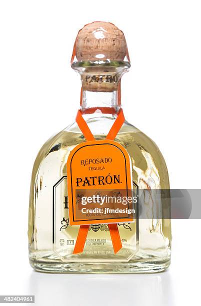 reposado patron tequila bottle with orange tag - lechuguilla cactus stock pictures, royalty-free photos & images