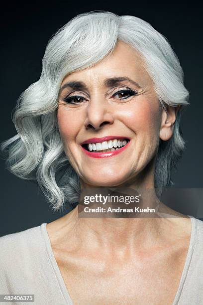 sivery, grey haired woman with a big smile. - mid length hair stock pictures, royalty-free photos & images