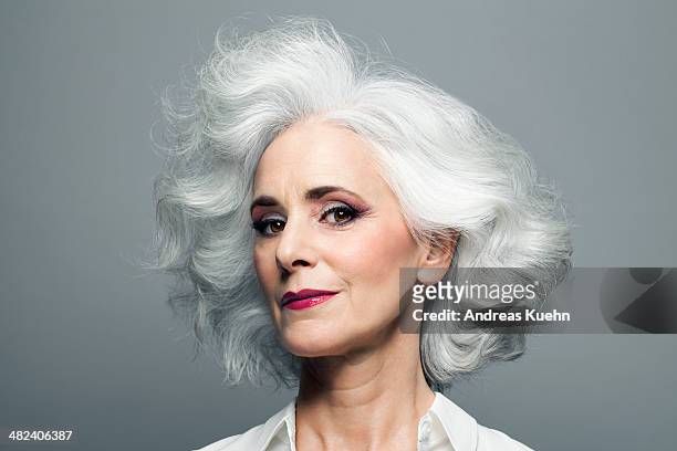 grey haired woman with red lip stick, portrait. - woman hair style fotografías e imágenes de stock