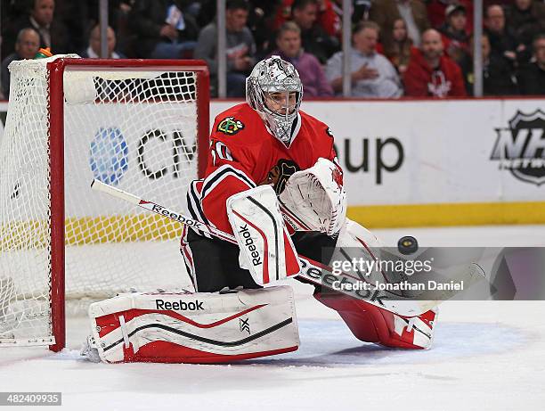Corey Crawford of the Chicago Blackhawks makes a save against the Minnesota Wild at the United Center on April 3, 2014 in Chicago, Illinois.