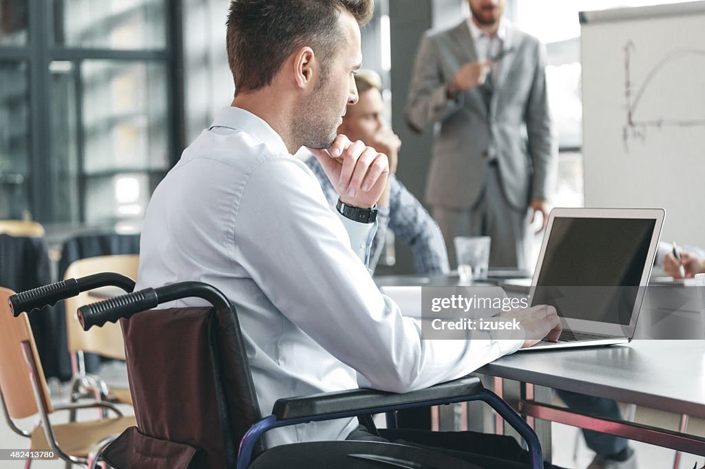 Disabled businessman working in an office