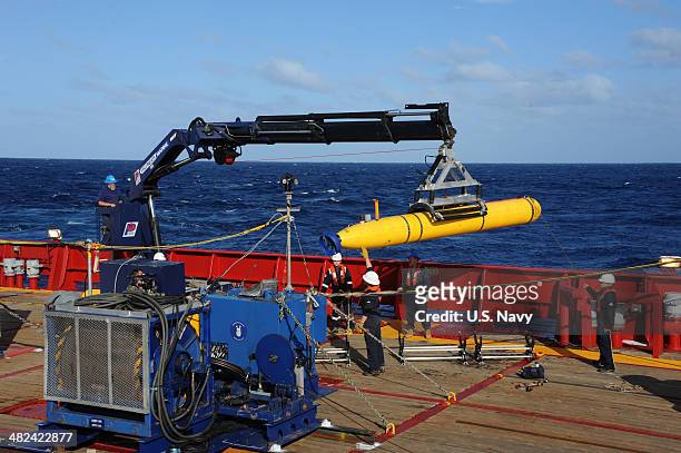 In this handout image provided by the U.S. Navy, The Bluefin 21, Artemis autonomous underwater vehicle is hoisted back on board the Australian...