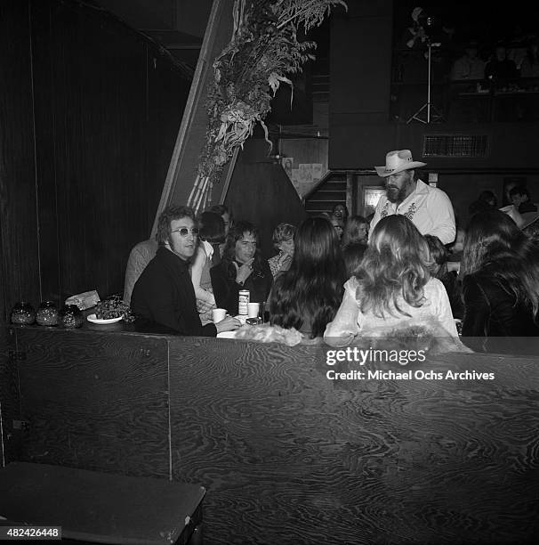 Drinking buddies known as 'The Hollywood Vampires' (L-R -- John Lennon and Alice Cooper celebrate an early Thanksgiving watching singer Anne Murray...