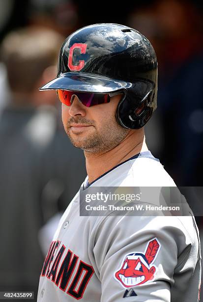 Nick Swisher of the Cleveland Indians looks on from the dugout before the start of his game against the Oakland Athletics at O.co Coliseum on April...