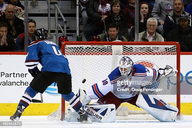 Tyson Barrie of the Colorado Avalanche scores the game winning goal against goalie Henrik Lundqvist of the New York Rangers in an overtime shootout...